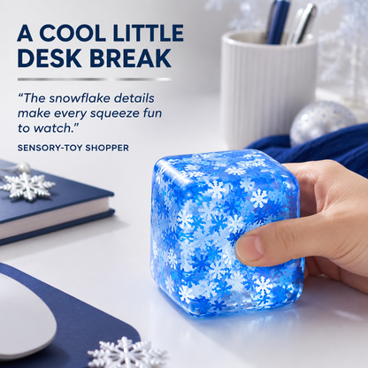 Blue snowflake cube sensory squeeze toy in a winter-inspired desk scene