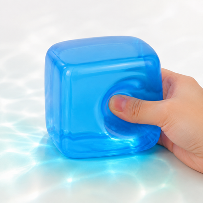 Blue transparent squeeze cube with hand pressing the toy