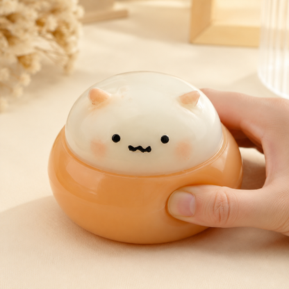 Hand pressing a chestnut puppy sensory squeeze toy