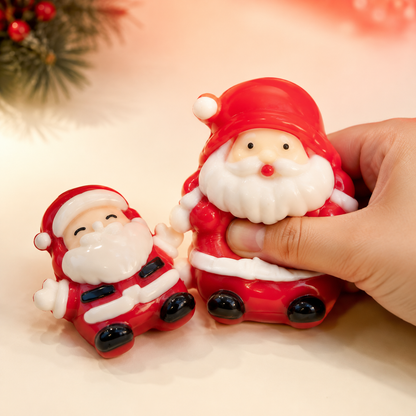 Hand pressing upright Santa beside reclining Santa sensory toy