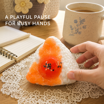 Egg rice-ball sensory toy in a cozy desk scene