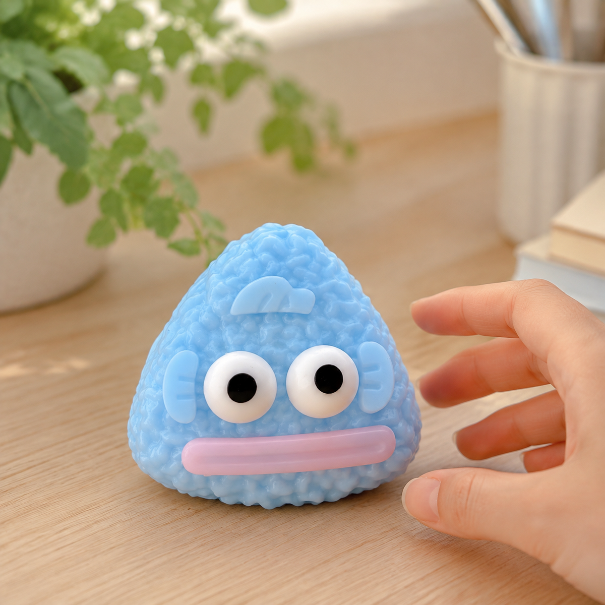 Funny fish rice-ball sensory toy on a cozy desk