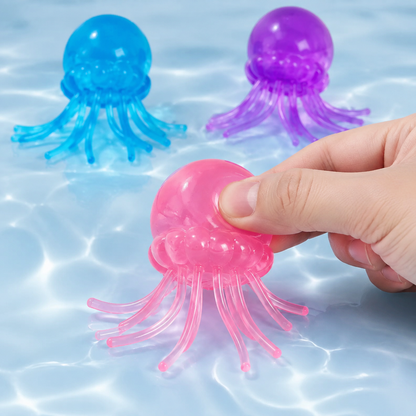 Pink blue and purple gel jellyfish toys with a hand pressing the pink toy
