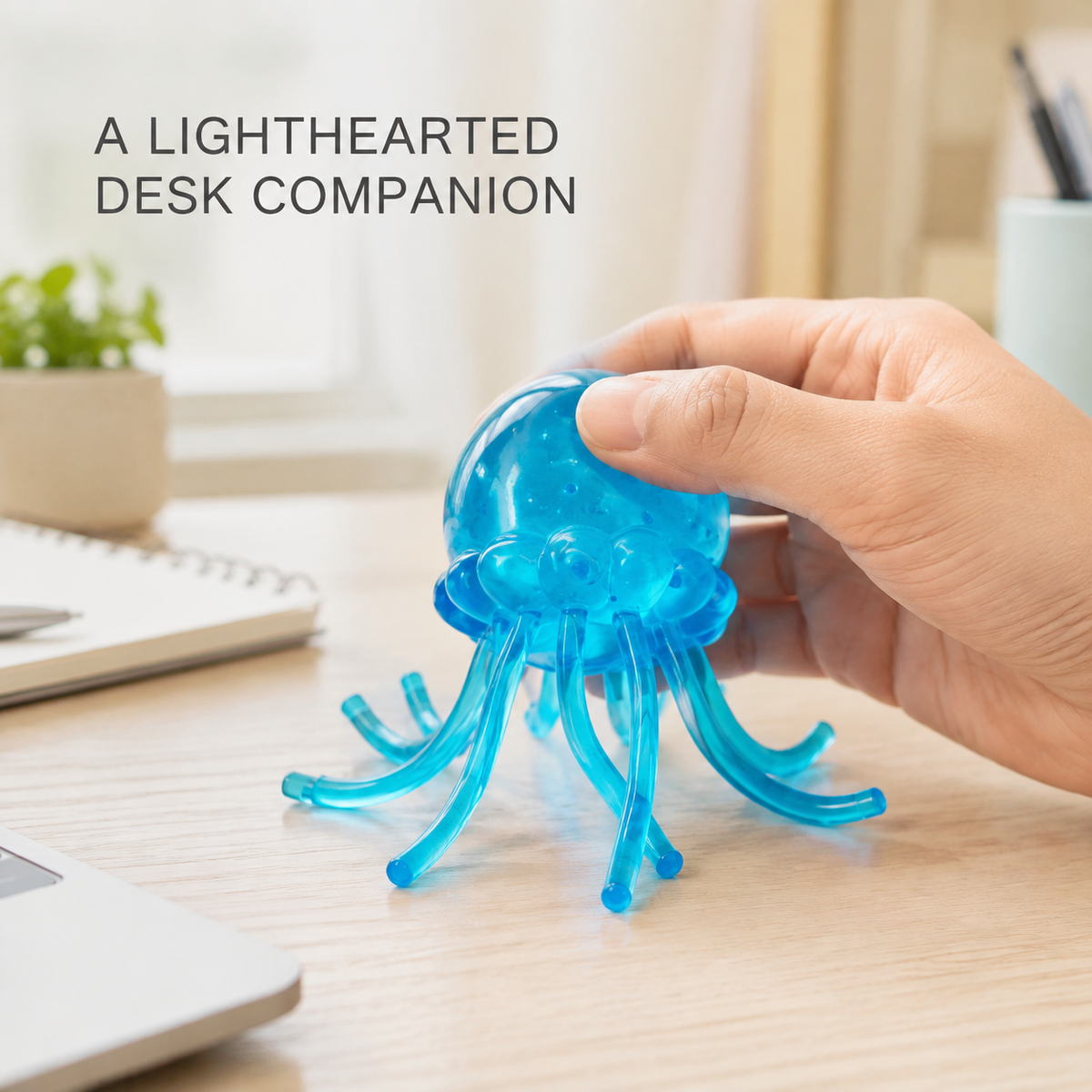Blue gel jellyfish toy in a bright home-office scene