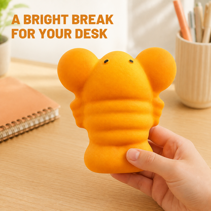 Large orange lobster squishy in a bright home-office scene
