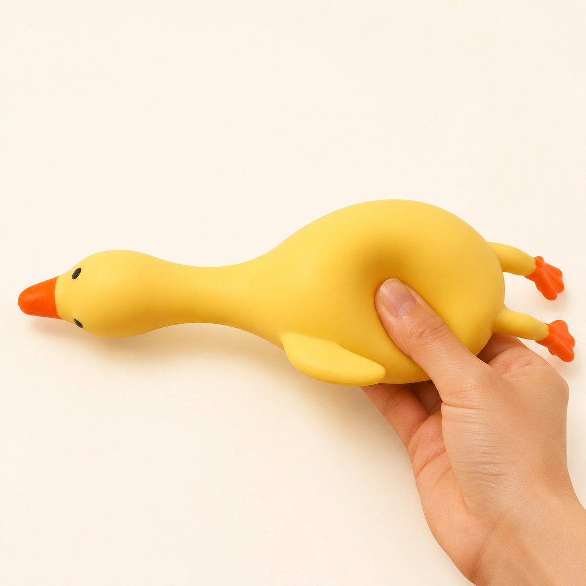 Long-neck duck squeeze toy with hand pressing the body