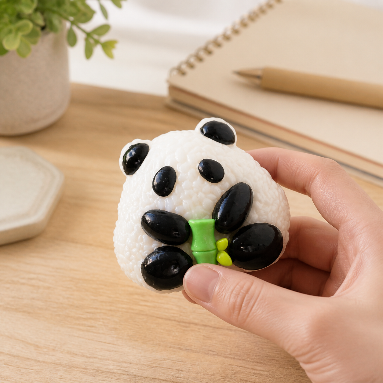 Panda rice-ball sensory toy on a cozy desk