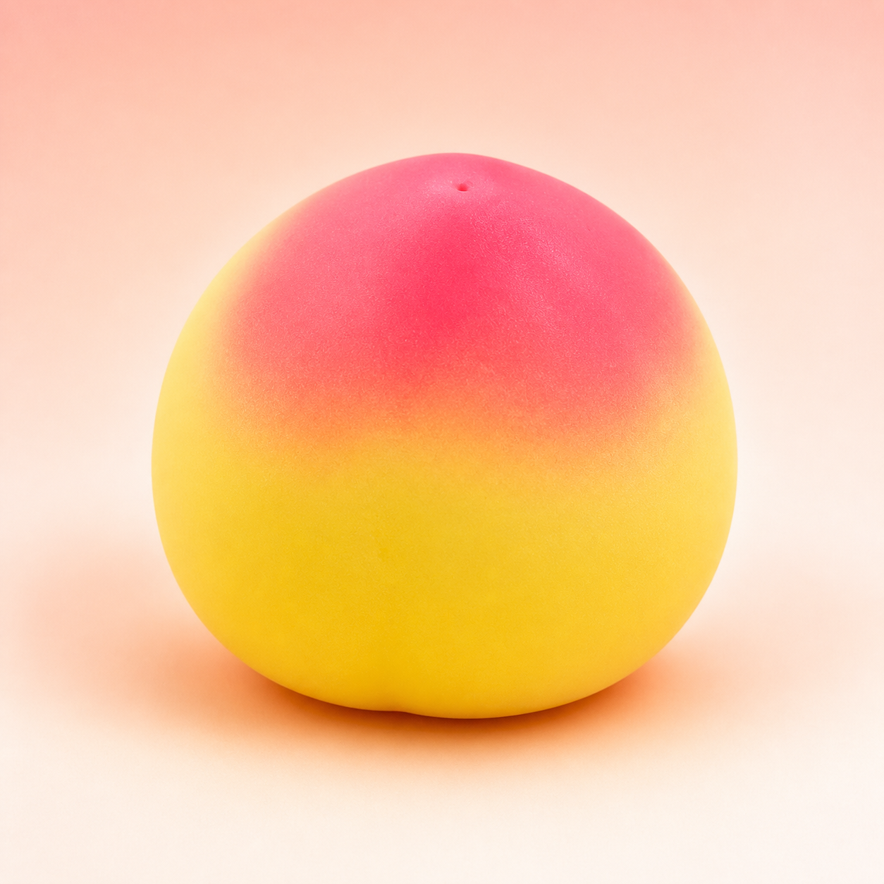 Yellow-to-pink peach squishy toy