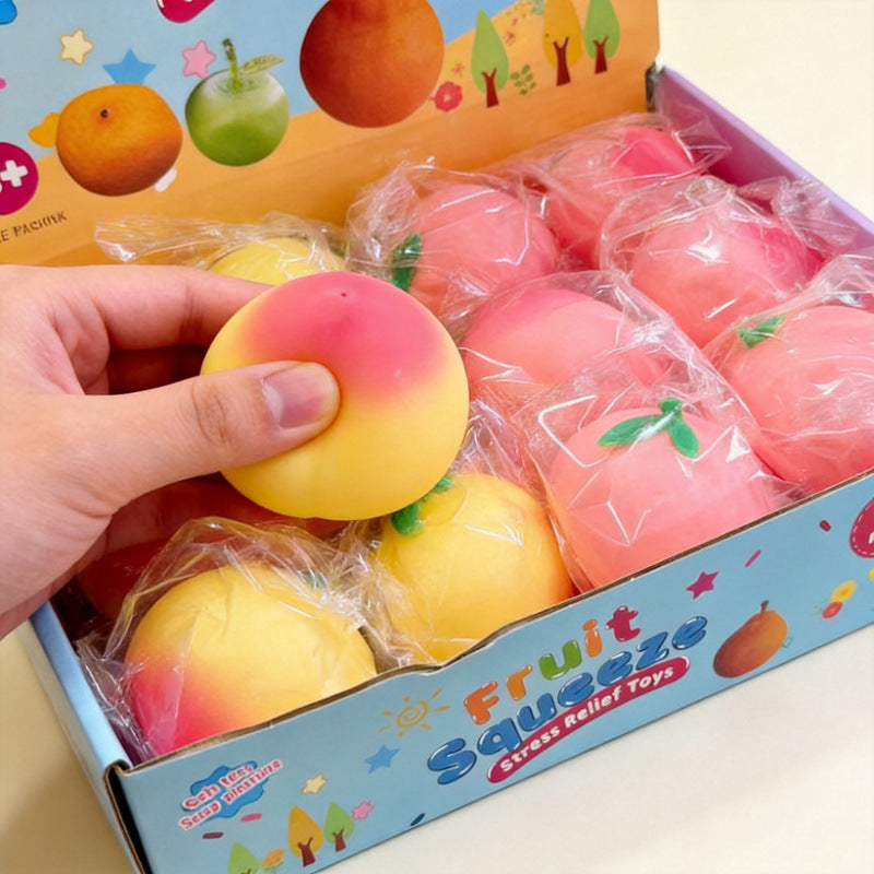 Peach squishy being squeezed by hand