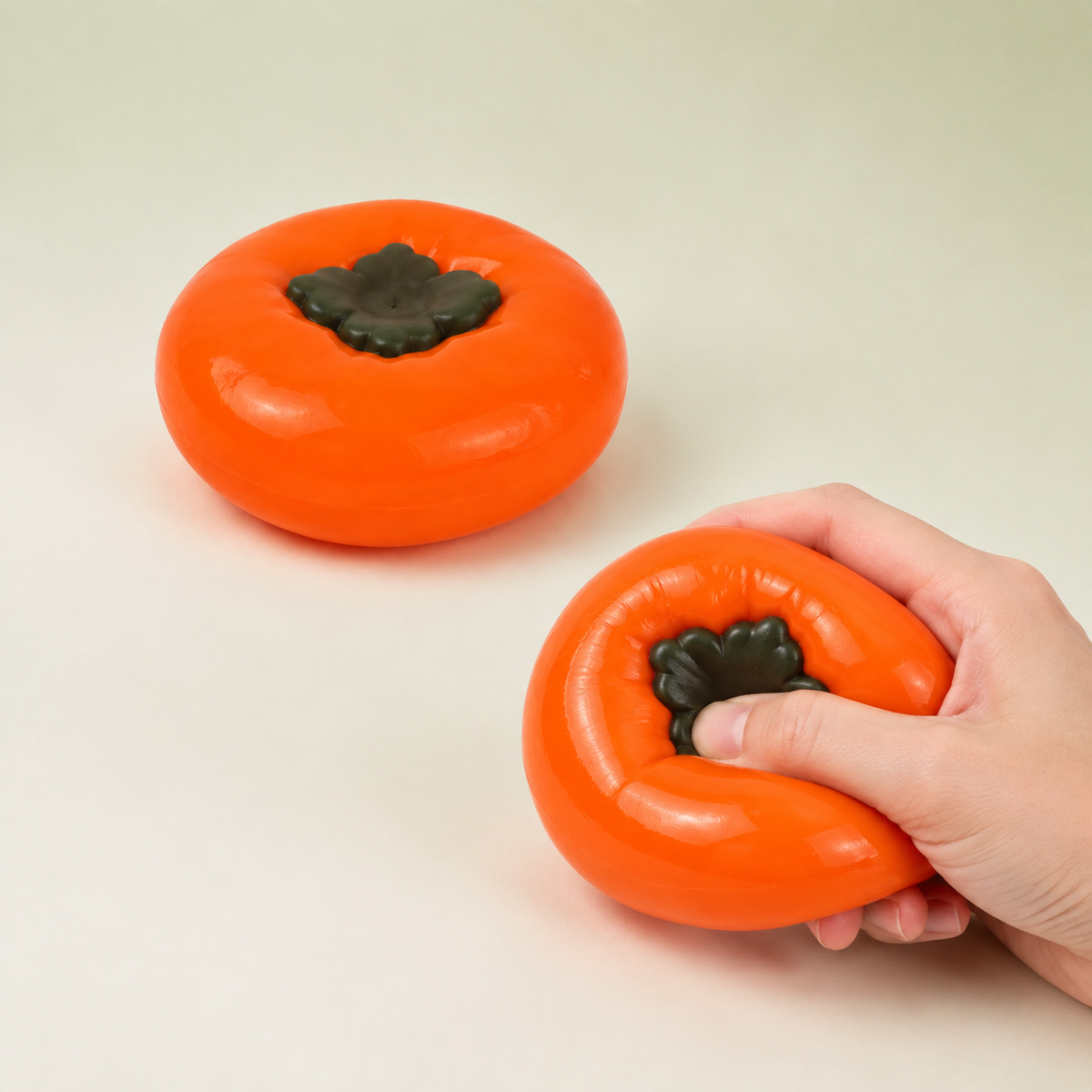 Persimmon fluid-filled sensory squeeze toy hero with hand-squeeze demonstration