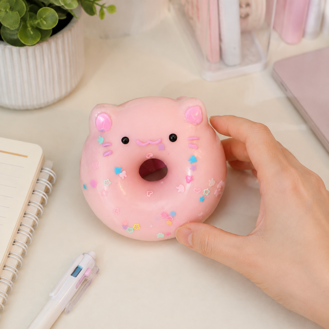 Pink pig donut sensory toy on a cozy desk