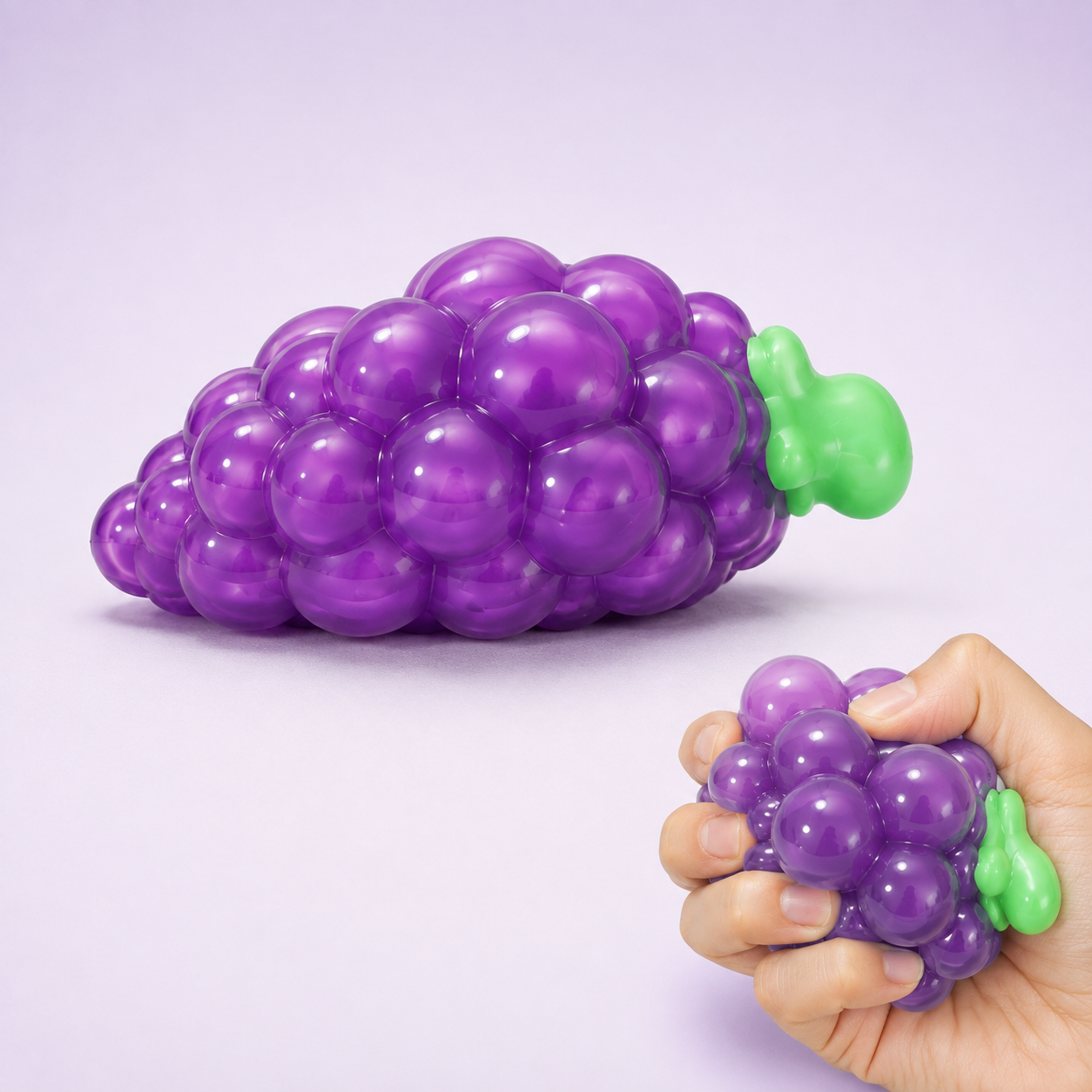 Purple grape sensory squeeze toy hero with hand squeeze