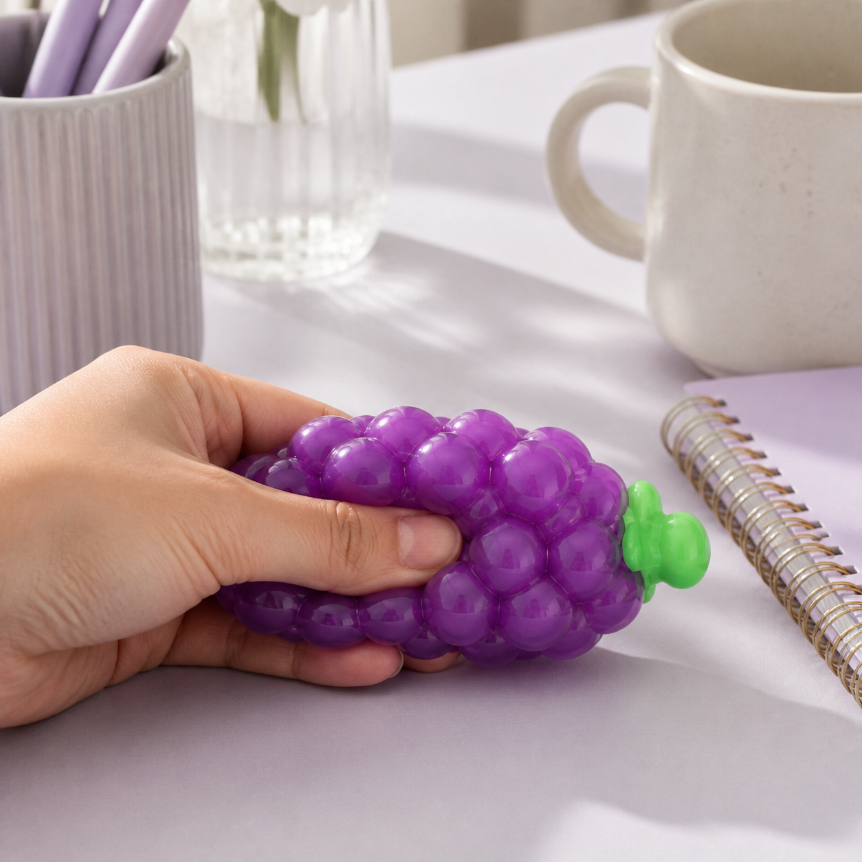 Purple grape sensory squeeze toy desk break lifestyle
