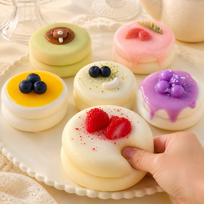 Six soufflé cake styles with a hand pressing strawberry cream