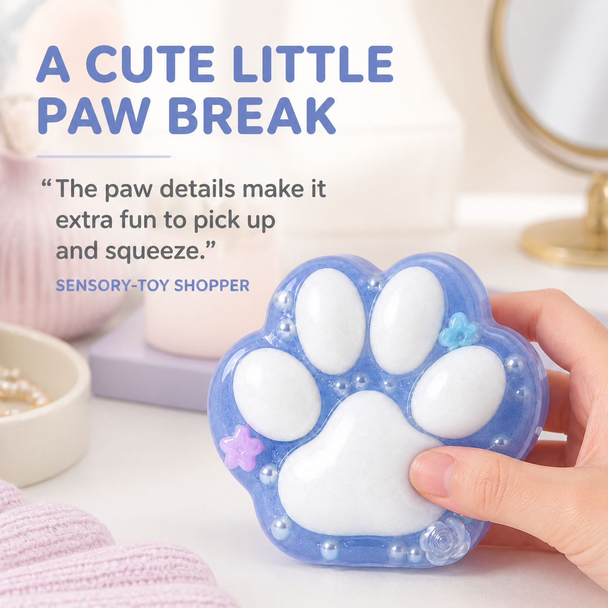 Translucent blue cat-paw sensory toy in a soft vanity lifestyle scene