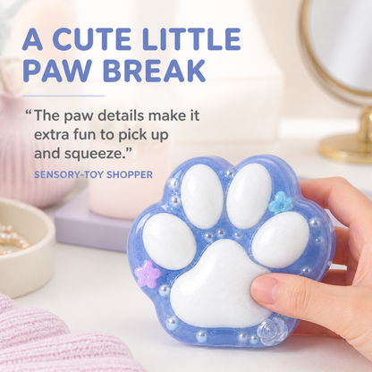 Translucent blue cat-paw sensory toy in a soft vanity lifestyle scene