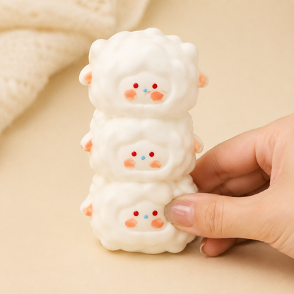 Hand pressing the bottom lamb of a triple-lamb sensory toy