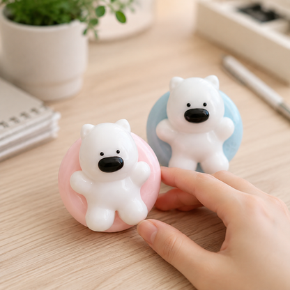 Pink and blue Westie swim-ring squeeze toys on a cozy desk